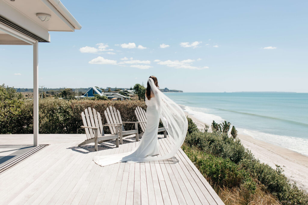 Bride getting ready for her Old Forest School wedding at beachfront accommodation in Pukehina.