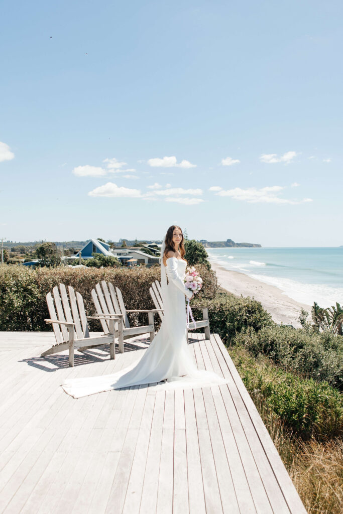 Bride getting ready for her Old Forest School wedding at beachfront accommodation in Pukehina.