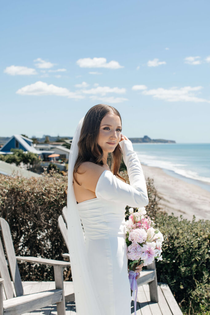 Bride getting ready for her Old Forest School wedding at beachfront accommodation in Pukehina.